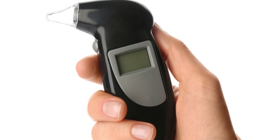 Woman holding a breathalyzer